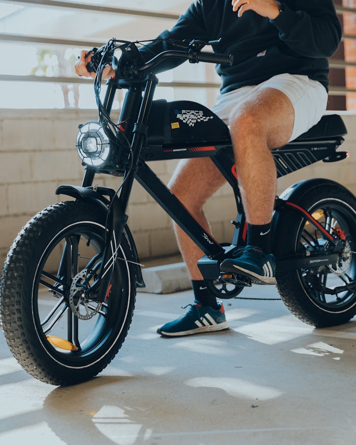 A man enjoying a ride on an electric bike in a Los Angeles parking area.
